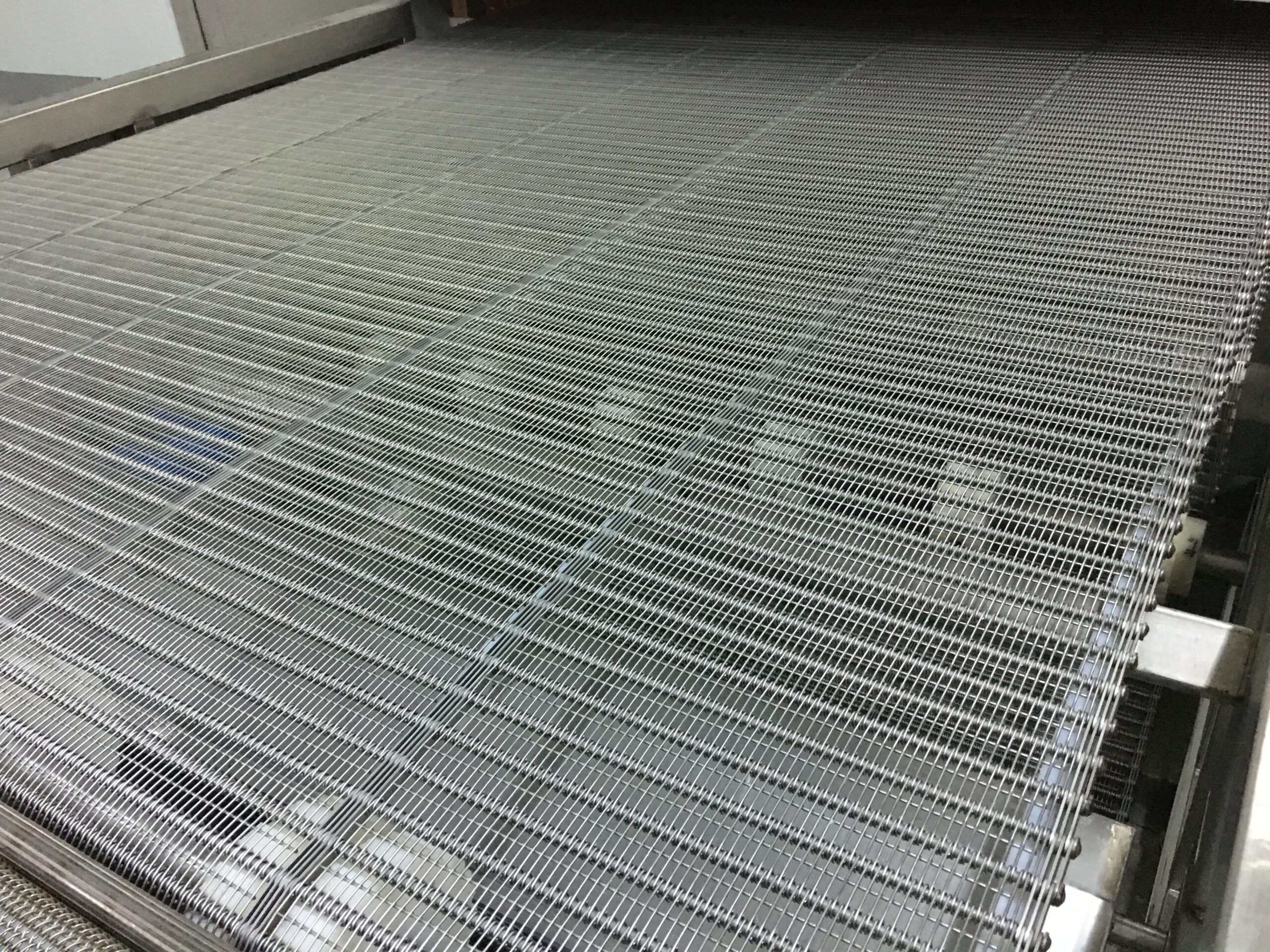 Stainless steel mesh belt inside a Square impingement tunnel freezer